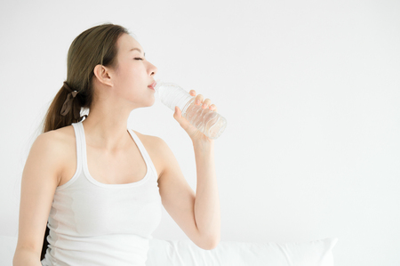 Asian beauty woman drink clean water in morning for healthyの写真素材