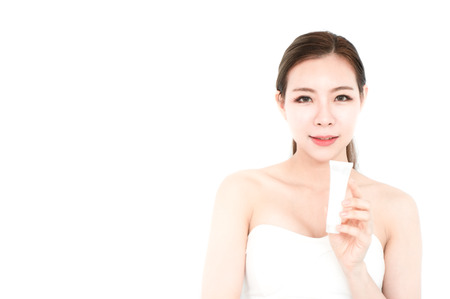 Asian beauty woman present skin product on white backgroundの写真素材