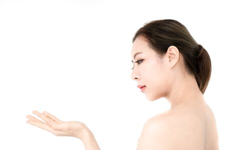 Asian beauty woman present skin product on white backgroundの写真素材