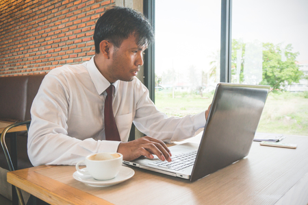 Businessman working in coffee shopの写真素材