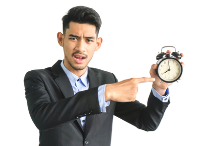 Boss hold a alarm clock to remind to start working on time not late on white backgroundの写真素材