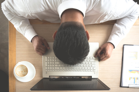 Businessman stress during working on tableの写真素材