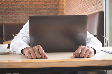 Businessman stress during working on tableの写真素材