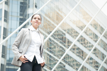 Business woman in suit look to future on building background in city outdoorの写真素材