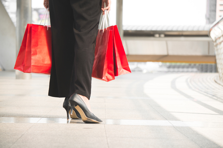 Shopping woman hold shopping bag on walking way in cityの写真素材