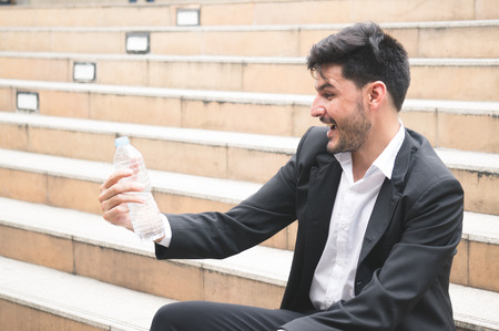 Businessman refresh by water bottle for health conceptの写真素材