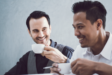 Businessmen meeting in office with coffee cup in morningの写真素材