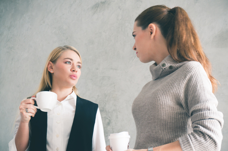 Working women discuss in office during coffee breakの写真素材