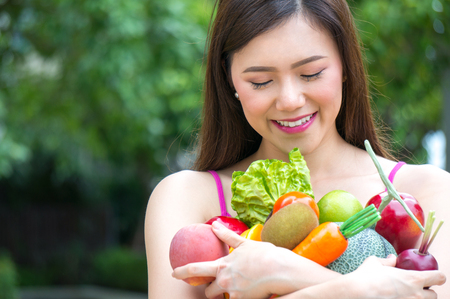 Asian healthy woman eat fruit for healthcare with slim bodyの写真素材