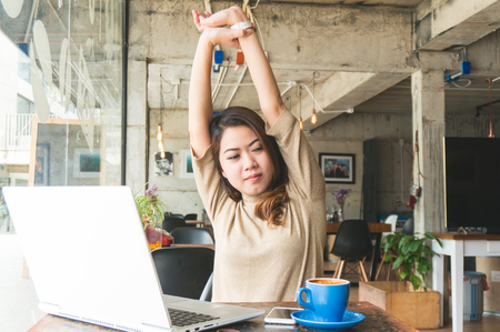 Asian woman working in coffee shop and stretchingの写真素材