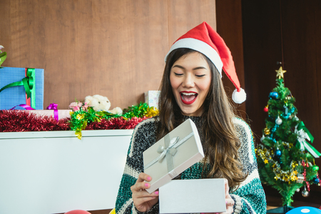 Asian woman send gift and open gift box of Christmas festivalの写真素材