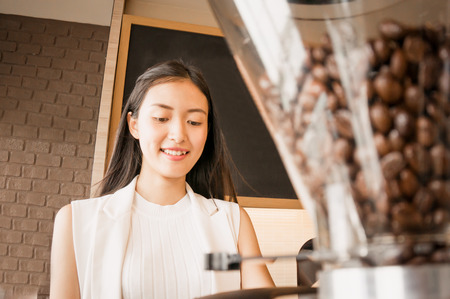Coffee bean in coffee machine with baristaの写真素材