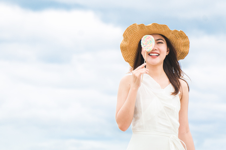 Asian woman relax on the beach in summer with sky and seaの写真素材