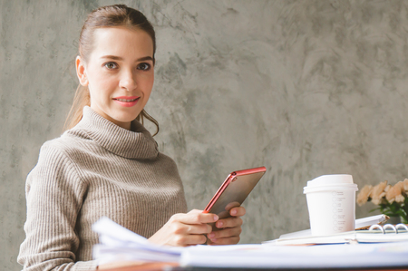 Freelance woman chatting with customer in cafÃ© via tabletの写真素材