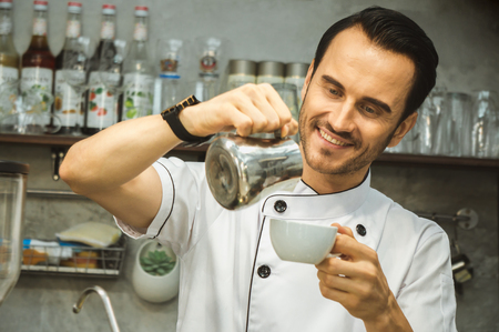 Bartender pour milk to coffee cupの写真素材