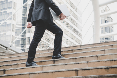 Businessman walk to office in cityの写真素材