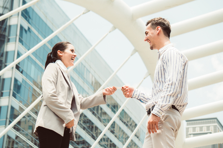 Businesswoman gives business card to colleagueの写真素材