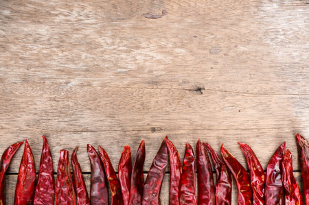 Dried Chillies in top line, ingredient for thai food on wood table backgroundの写真素材