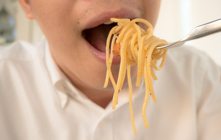 A man eat spaghetti for dinnerの写真素材