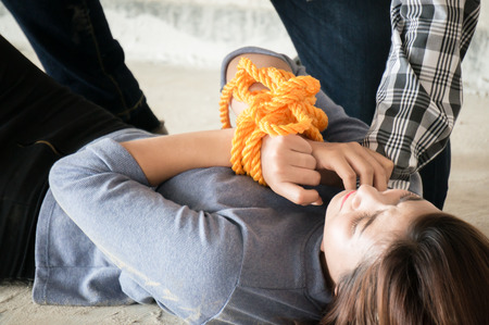 Asian woman send water bottle to friend among national park on forest backgroundの写真素材