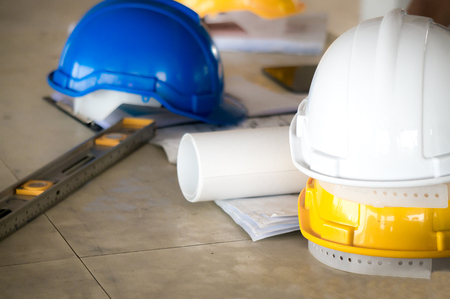 Safety helmet, ruler and drawing on table for engineering presentationの写真素材