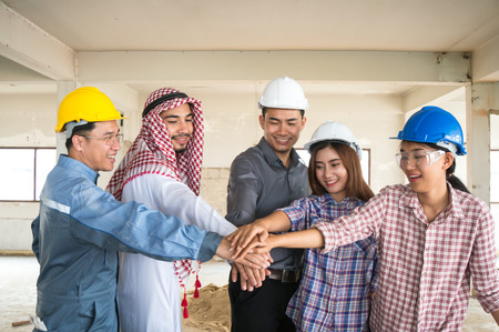 Engineer, Arab businessman and foreman cooperate on site