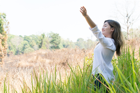 Asian woman feeling relax in green forestの写真素材