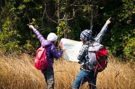 Asian travelers holding map and argue in forestの写真素材