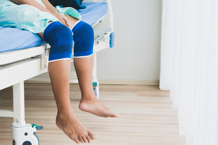 Old man have knee ache and rest in hospitalの写真素材