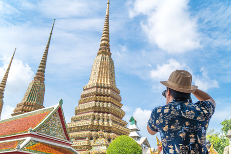Asian traveler shoots photo of Wat Pho temple in Thailand in vacation periodの写真素材