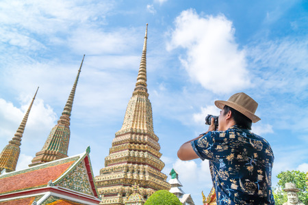 Asian traveler shoots photo of Wat Pho temple in Thailand in vacation periodの写真素材