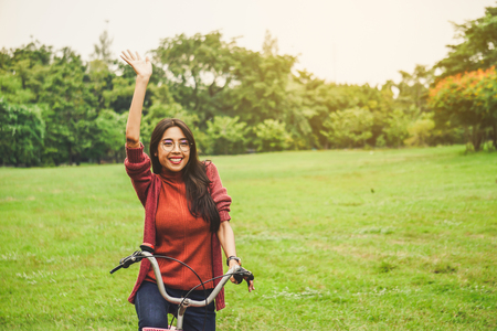 Asian woman say hello with friend in parkの写真素材