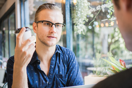 Businessman and partners discuss about business plan in cafÃ©の写真素材