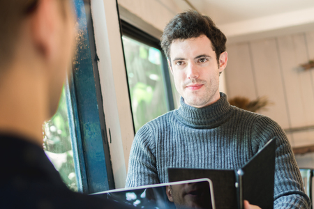 Businessman and partners discuss about business plan in cafÃ©の写真素材