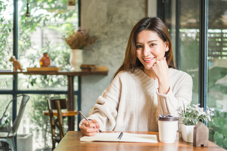 Asian woman working on labtop in coffee shopの写真素材