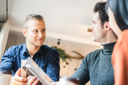 Businessman and partners discuss about business plan in cafÃ©の写真素材