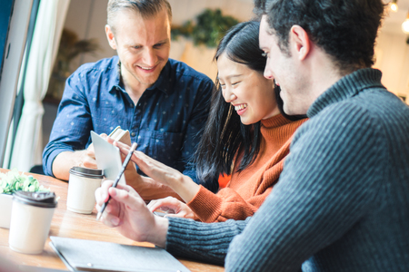 Businessman and partners discuss about business plan in cafÃ©の写真素材