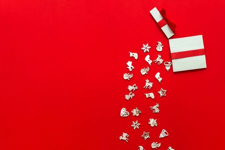 Christmas gifts presents paper art on red background with festive holiday decorationsの写真素材