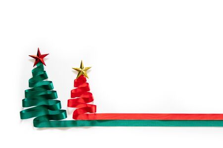 Christmas trees made from green and red ribbon with gold star on white background with coppy spaceの写真素材
