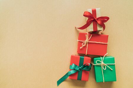 Christmas gifts on paper background with decoration, berries, star, snow flake and copy space. Flat lay, top viewの写真素材