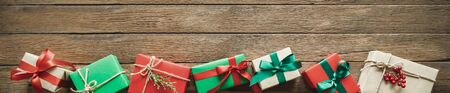 Christmas gifts on wood background with copy space. Flat lay, top viewの写真素材