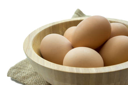 5 eggs in the wooden bowl isolated on white background.