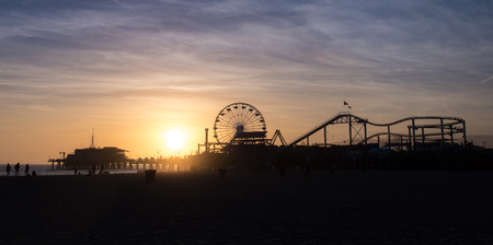 Silhouette of Santa Monica Pier sunset with cloud and blue sky, Los Angeles, USAの写真素材