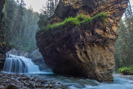 Johnston Canyon cave in Spring season with waterfalls, Johnston Canyon Trail, Alberta, Canada.の写真素材