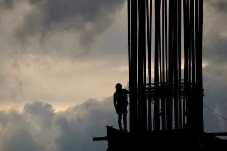 Worker on construction site in the morning silhouette