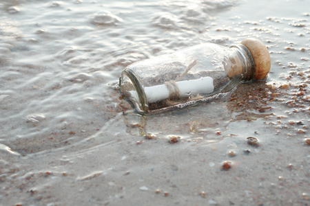bottle with a message on the beachの写真素材