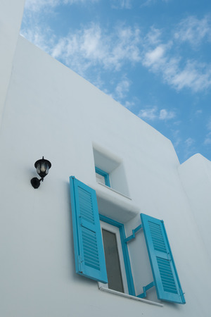 Blue windows in white buildings with blue skyの写真素材