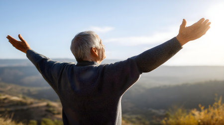 Elderly woman with arms outstretched on top of a mountain.ai generatedの素材