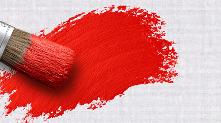 Paintbrush with red paint stroke on canvas background. Art conceptの素材