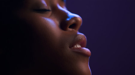 Close up portrait of beautiful african american woman on dark backgroundの素材